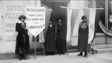 A photo of suffragettes holding a sign
