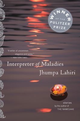 Interpreter of Maladies book cover.  Rocks on a beach with sunset image on the cover.