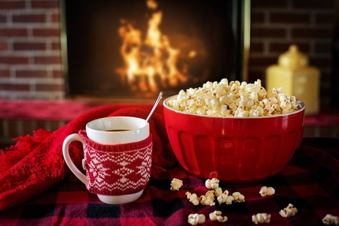 Image of a bowl of popcorn next to a cup of hot chocolate