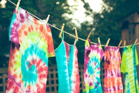 Image of tie-dye shirts hanging on a laundry line