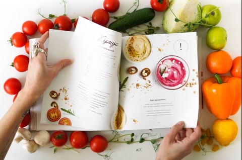 photo of an open cookbook and food nearby