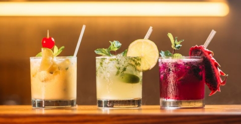 photo of three pretty mocktails with fruit garnishes