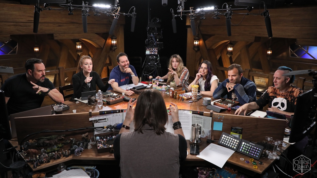 Image of voice actors sitting around table playing Dungeons and Dragons