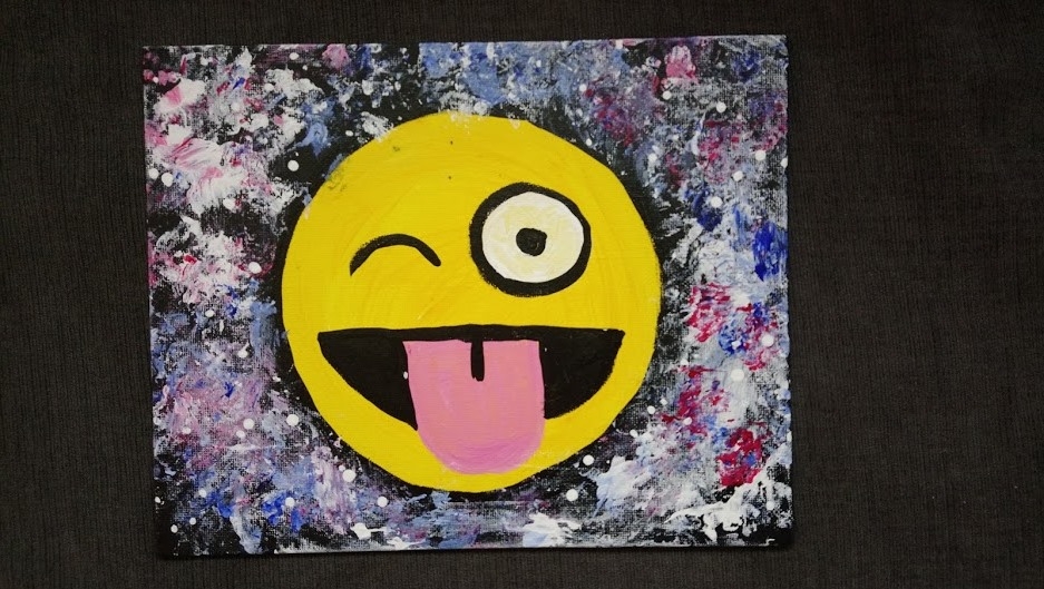 Image of winking tongue out emoji on canvas with galaxy background